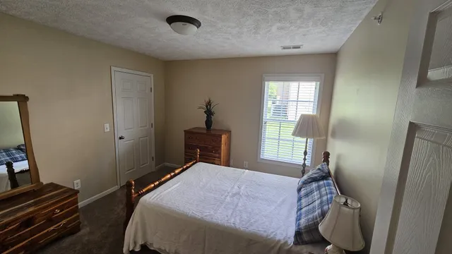 a bed room with a bed and a window