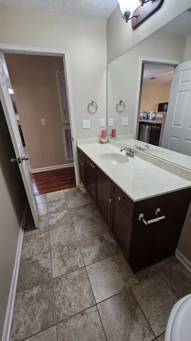 a bathroom with a sink vanity and mirror