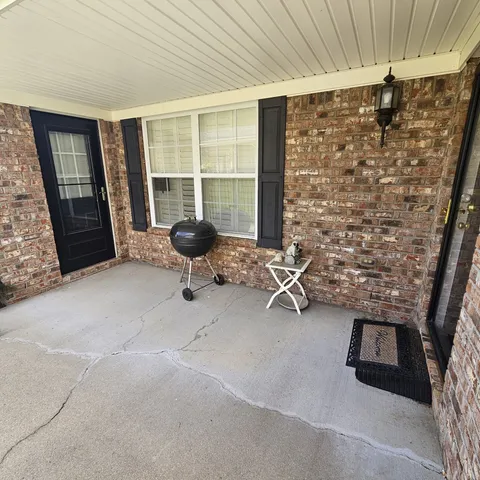 a room with pool table and windows