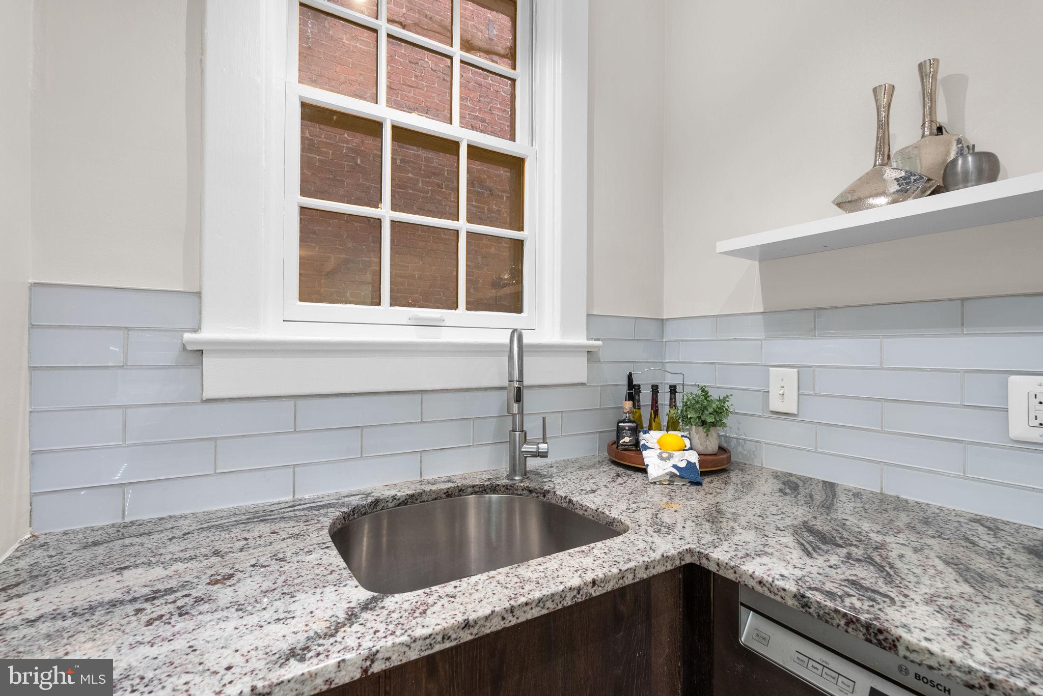 1705 Lanier Place Northwest, Unit 204 Washington, DC 20009 - Photo 15 of 26 Upgraded glass tile backsplash and granite counter