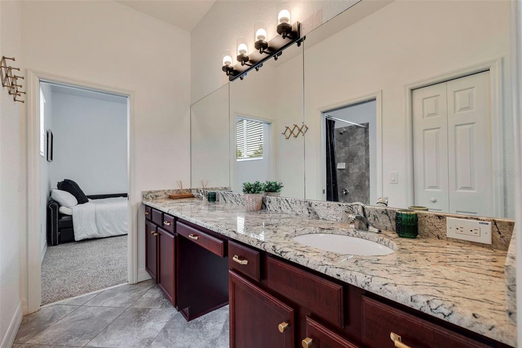 205 Bengal Circle Oldsmar, FL 34677 - Photo 23 of 40 a bathroom with a granite countertop double vanity sink and a mirror