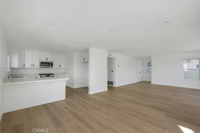 a kitchen with stainless steel appliances granite countertop a stove and a refrigerator