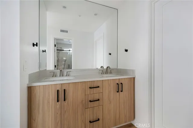 a bathroom with double sink and mirror
