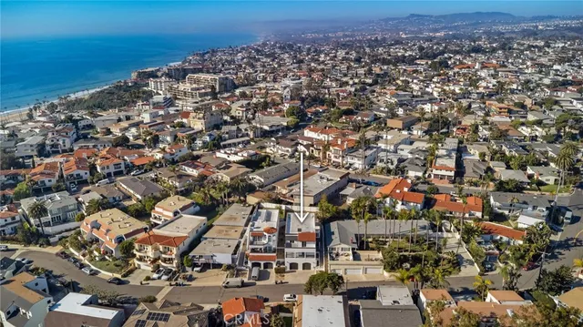 an aerial view of a building with ocean view