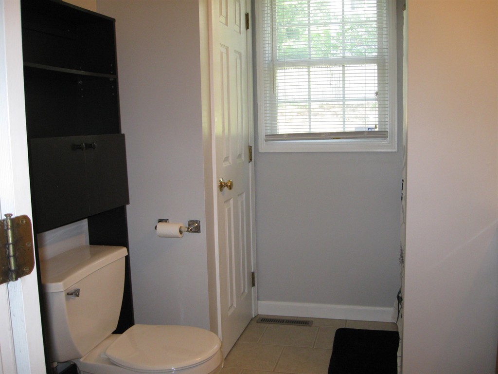 56 Gates Avenue Springfield, MA 01118 - Photo 16 of 30 a white toilet sitting next to a bathroom sink