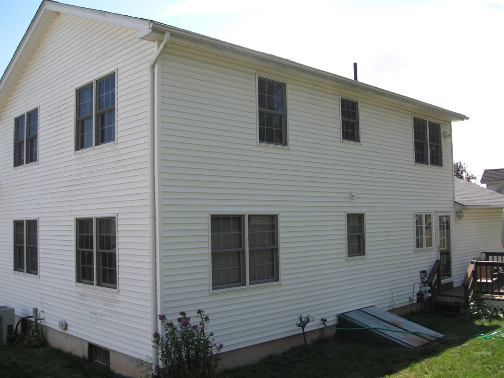 56 Gates Avenue Springfield, MA 01118 - Photo 3 of 30 a view of a house with a small yard and large window