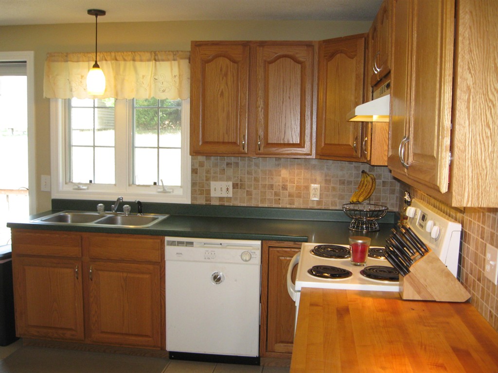 56 Gates Avenue Springfield, MA 01118 - Photo 6 of 30 a kitchen with a sink a stove cabinets and a wooden floor