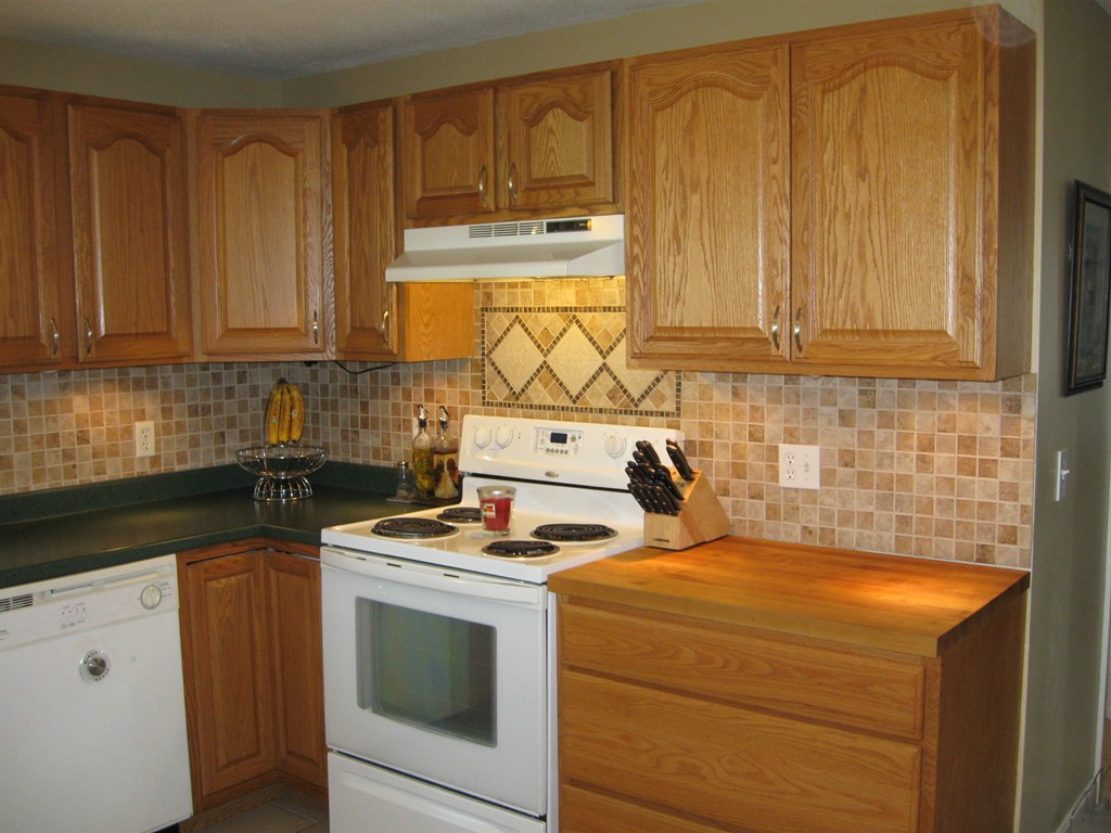 56 Gates Avenue Springfield, MA 01118 - Photo 7 of 30 a kitchen with granite countertop cabinets and white appliances