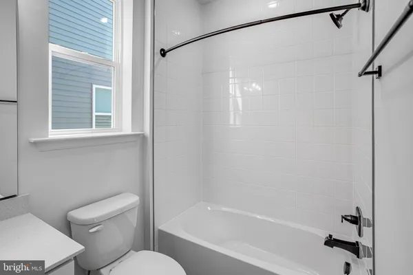 a bathroom with a toilet and a bathtub