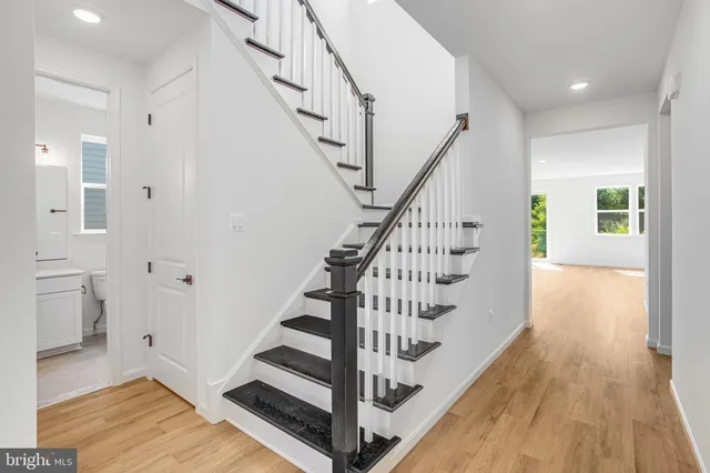 a view of entryway and hall with wooden floor