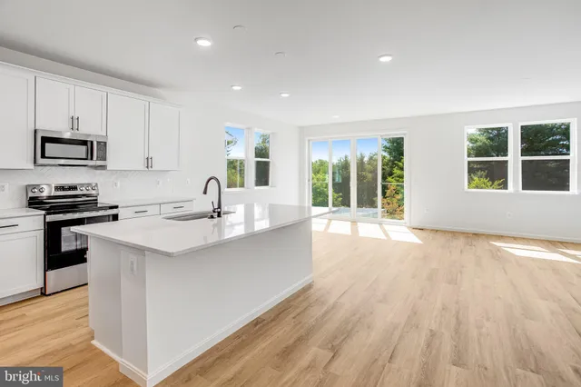 a kitchen with granite countertop a stove and a sink