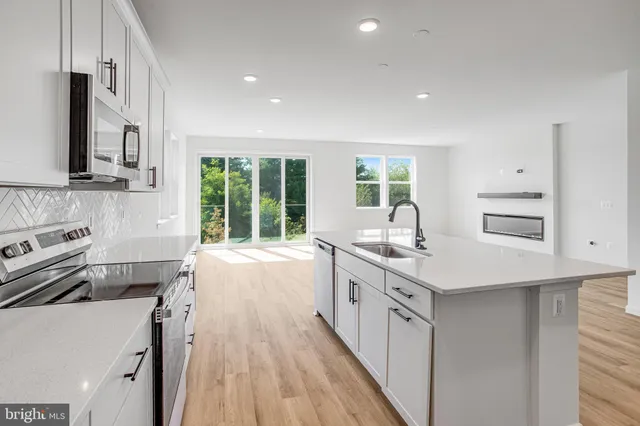 a kitchen with a sink stove and cabinets