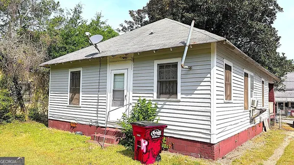 a view of a small house with yard