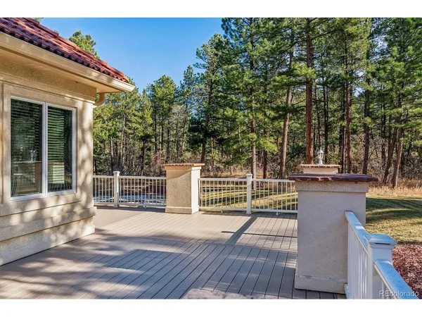 a view of a livingroom with a fireplace cabinet and windows