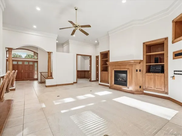 a view of an empty room with a fireplace and a window