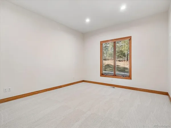 a bathroom with a granite countertop sink a toilet and a mirror