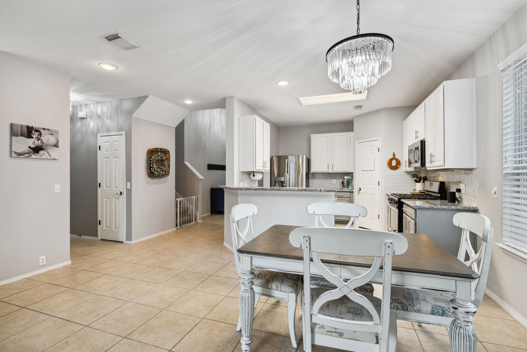 3526 Azalea Sands Drive Spring, TX 77386 - Photo 12 of 39 a kitchen with stainless steel appliances kitchen island granite countertop a refrigerator and microwave