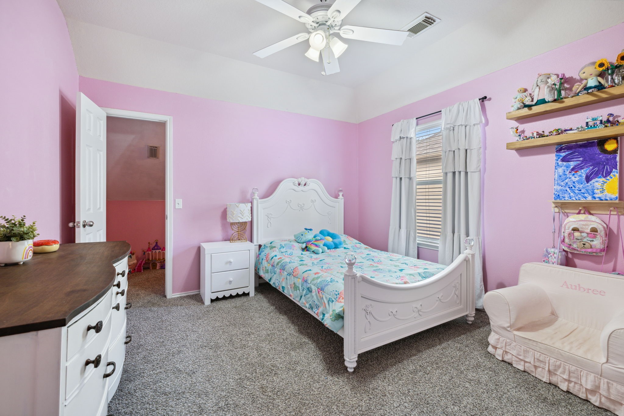 3526 Azalea Sands Drive Spring, TX 77386 - Photo 30 of 39 a bedroom with a bed and a chandelier