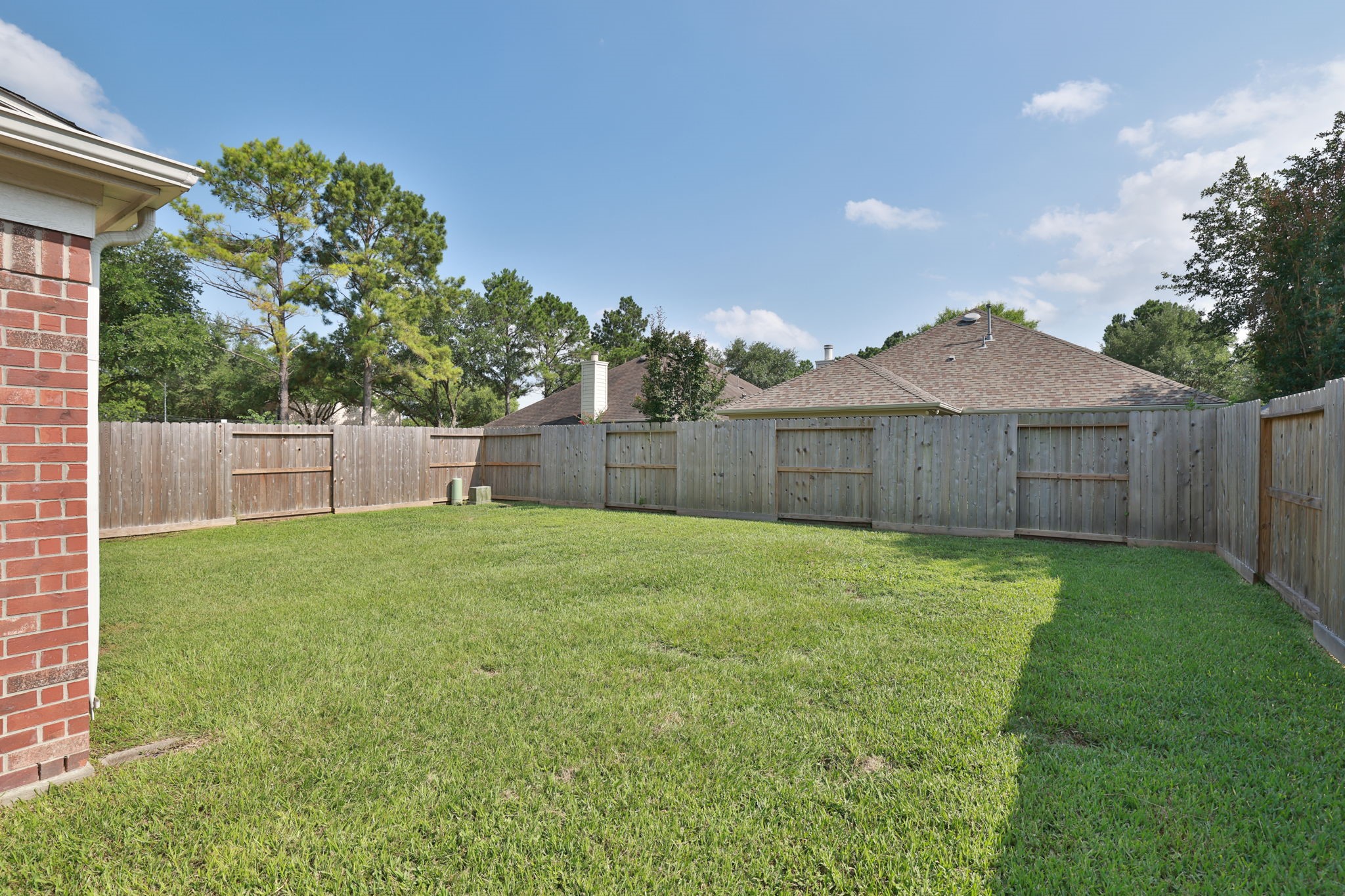 3526 Azalea Sands Drive Spring, TX 77386 - Photo 36 of 39 a view of a backyard with table and chairs and wooden fence