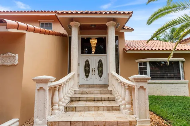 swimming view of a house with a porch