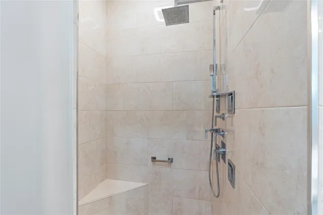 a bathroom with a sink a mirror and a shower