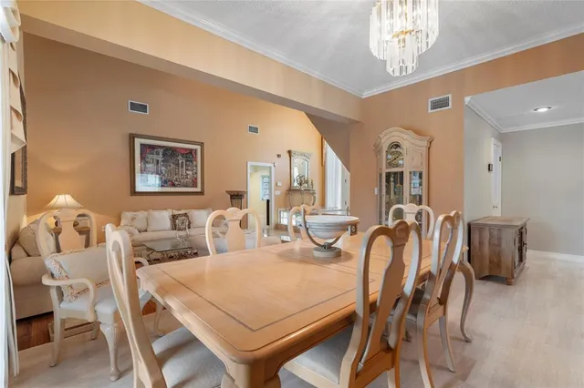 a living room with furniture a window and a flat screen tv