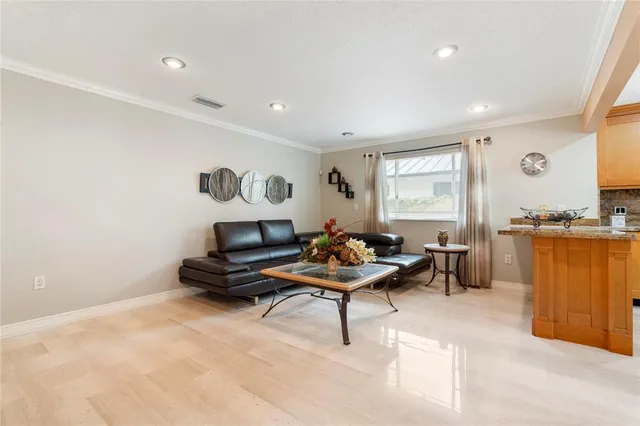 a living room with furniture and view of kitchen