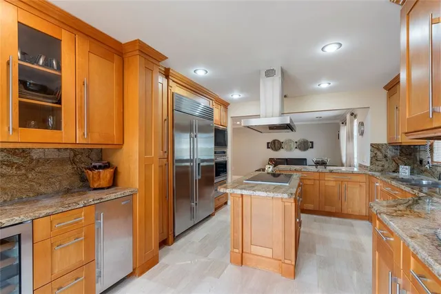 a kitchen with granite countertop a sink and stainless steel appliances