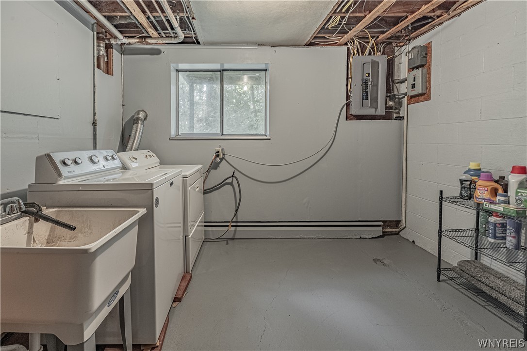 6775 Bear Ridge Road Pendleton, NY 14094 - Photo 35 of 48 An unfinished ceiling and concrete floors define this utility-focused basement laundry space.