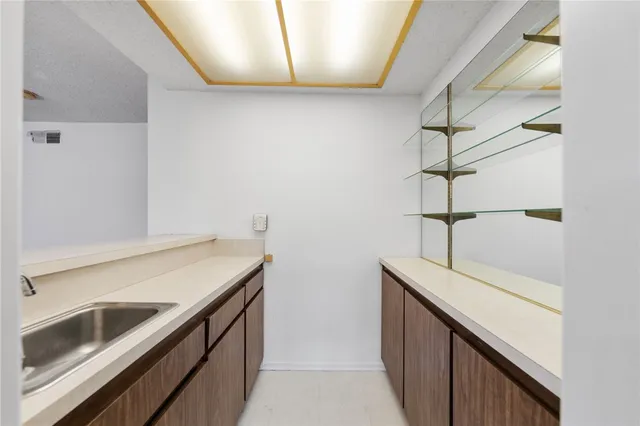 a kitchen with a sink and cabinets