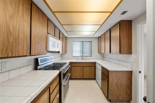 an empty room with a window and a ceiling fan