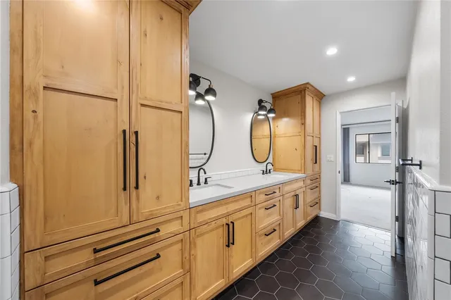 a bathroom with a double vanity sink and mirror