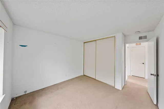 an aerial view of residential building and trees around