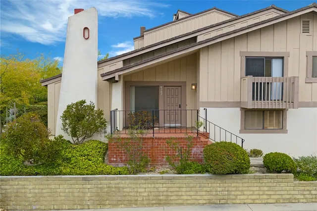 a front view of a house with lots of trees