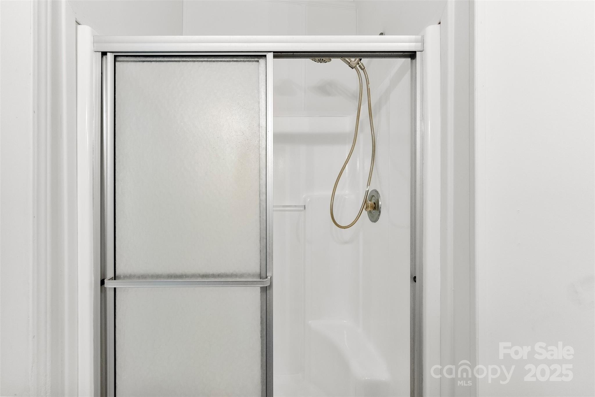 2121 Hephzibah Church Road Bessemer City, NC 28016 - Photo 18 of 41 a bathroom with a glass shower door