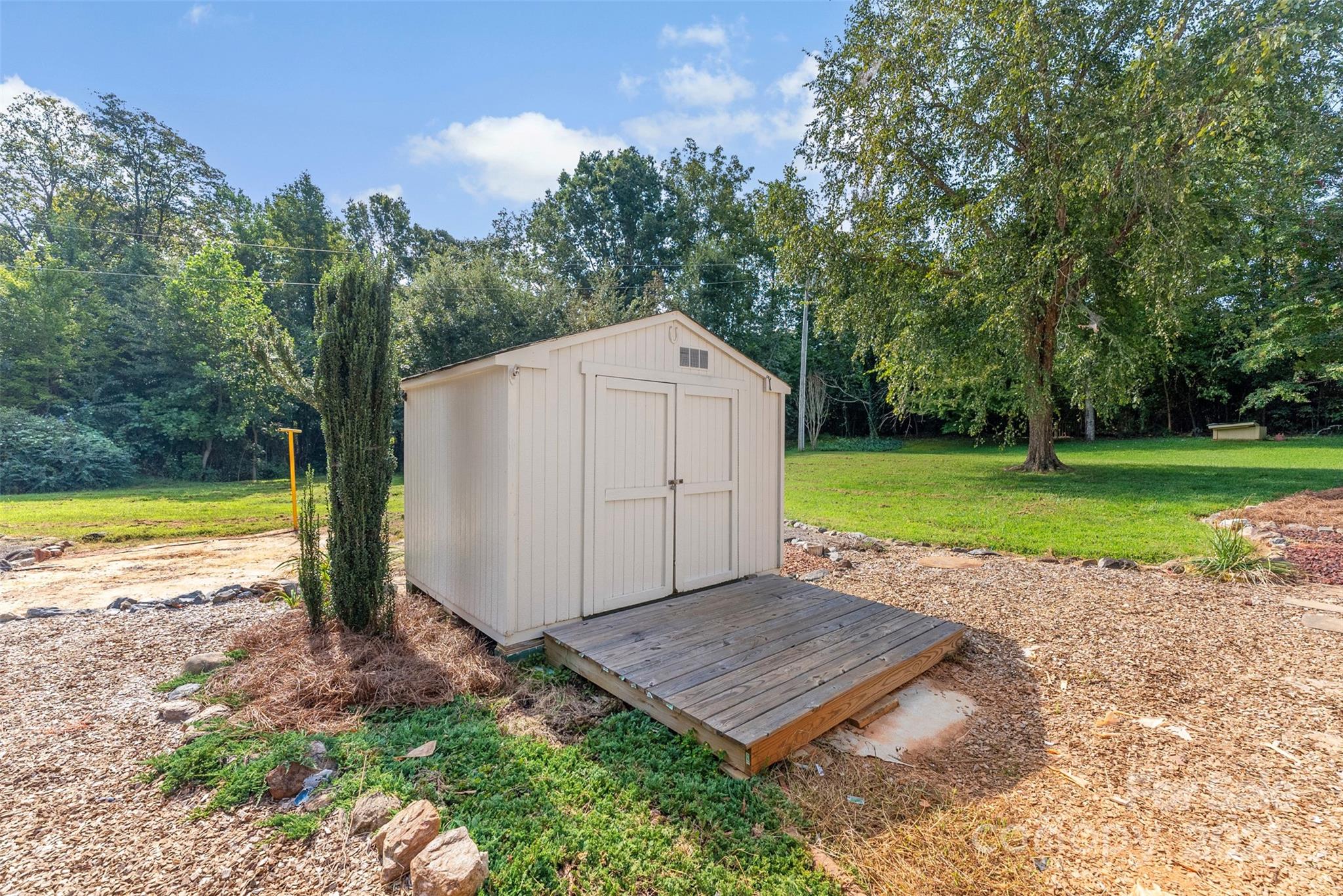2121 Hephzibah Church Road Bessemer City, NC 28016 - Photo 34 of 41 a view of a backyard with a small cabin