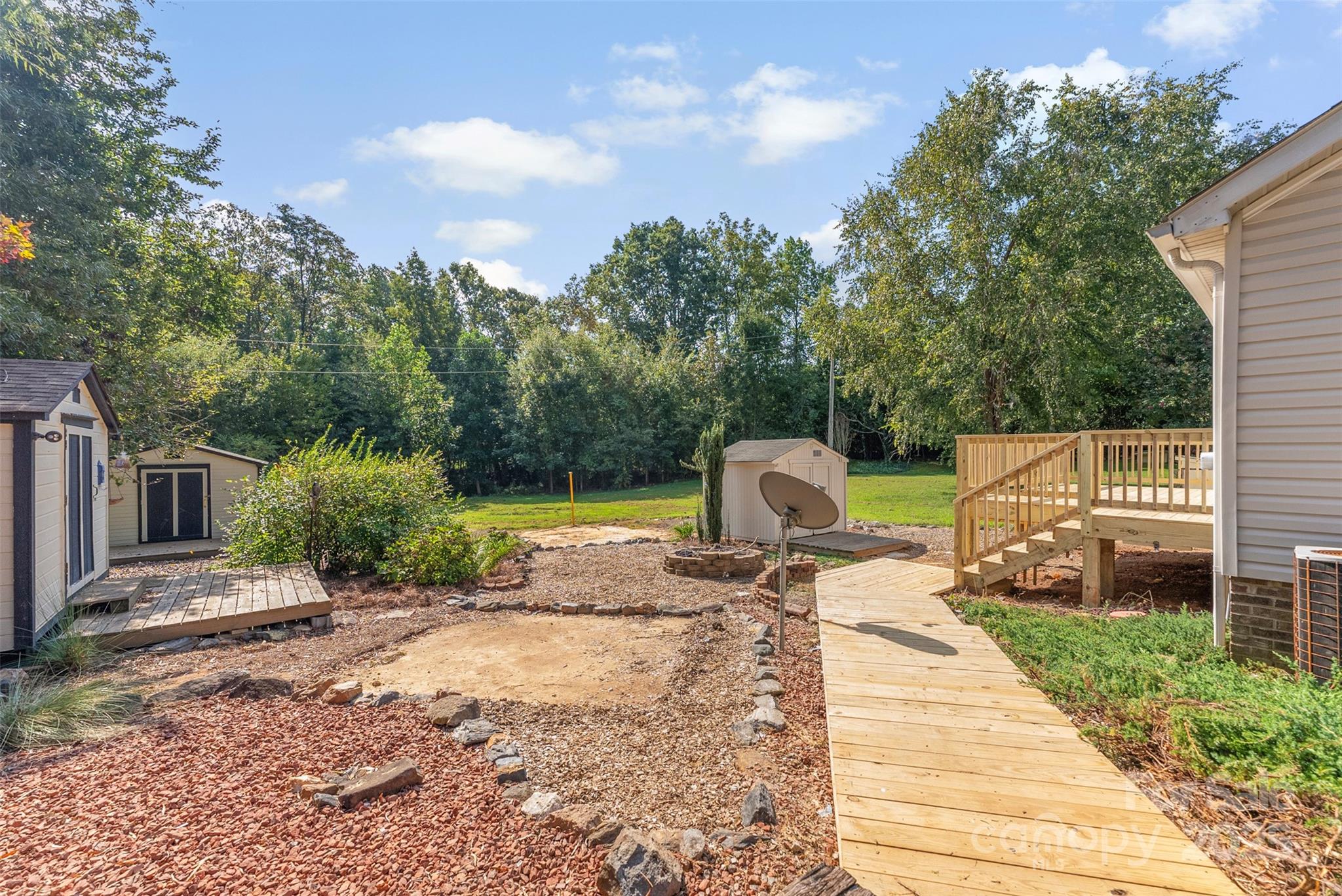2121 Hephzibah Church Road Bessemer City, NC 28016 - Photo 37 of 41 a view of a chairs and fire pit in the patio with a yard