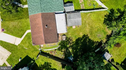 an aerial view of residential house with pool and garden