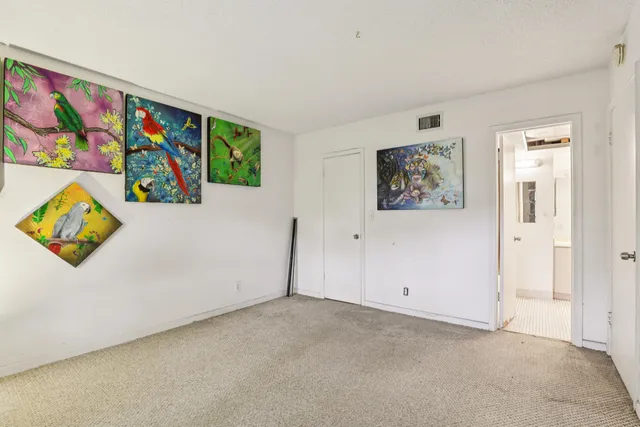 a bathroom with a granite countertop sink and white cabinets