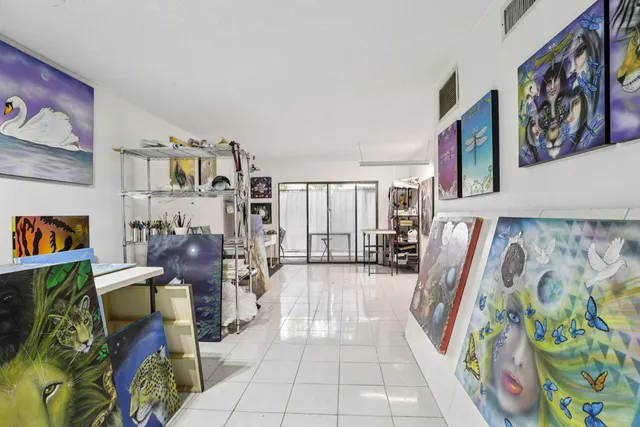 a view of a hallway with windows and furniture