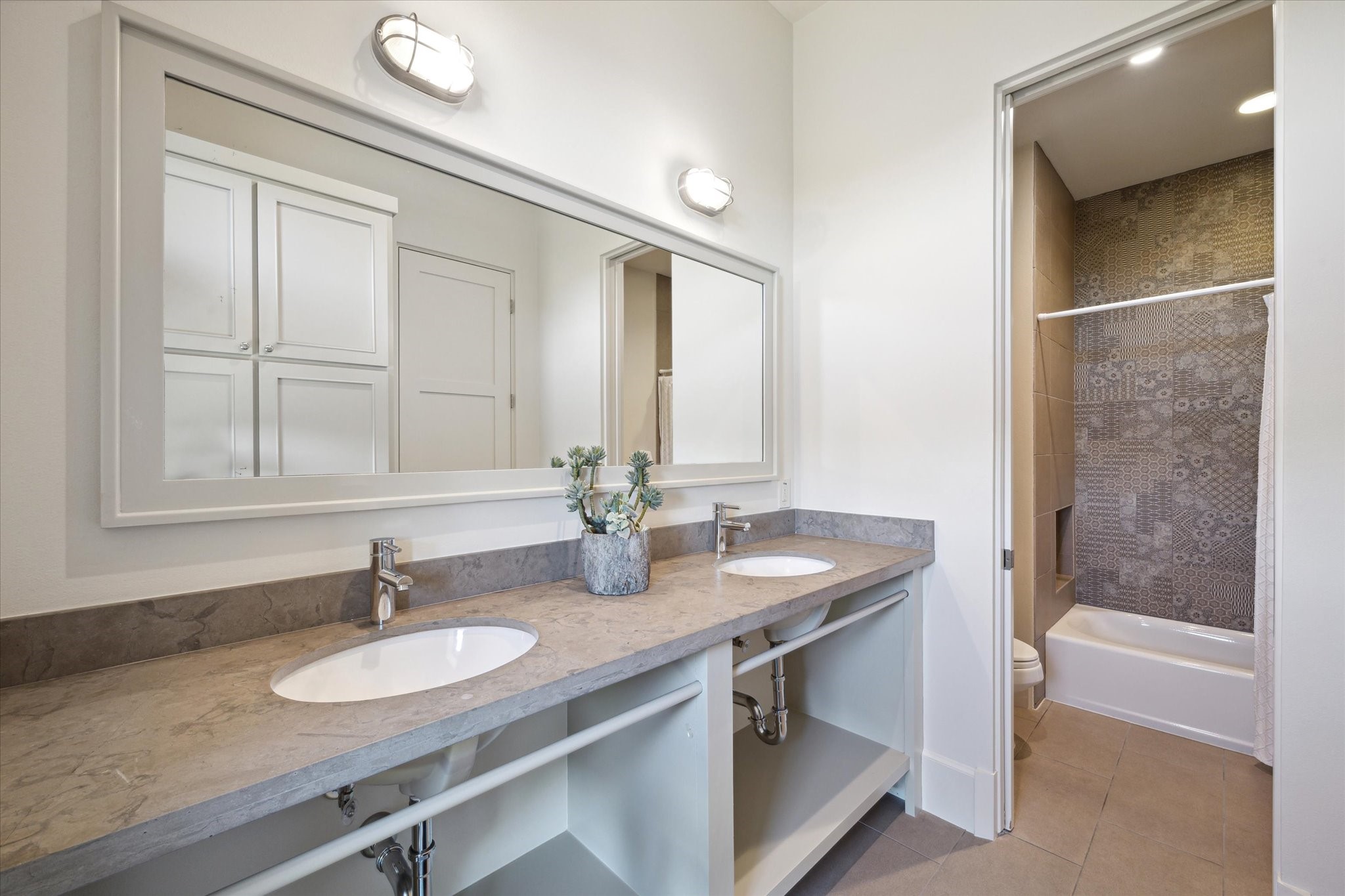 633 Quintana Roo Place Seabrook, TX 77586 - Photo 31 of 47 The bunk room's en suite bathroom has double sinks and a shower/tub combo.