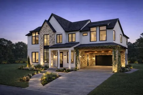 a front view of a house with yard and green space