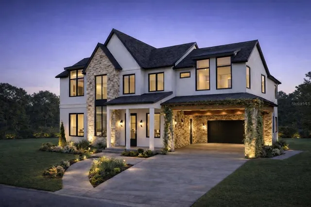 a front view of a house with yard and green space