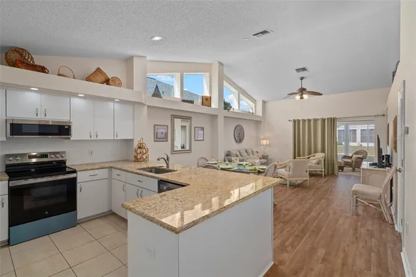 a kitchen with stainless steel appliances granite countertop a stove oven and a sink with cabinets