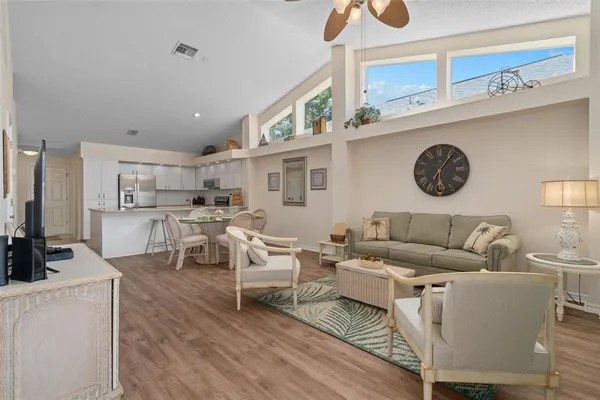 a living room with furniture a rug and a clock