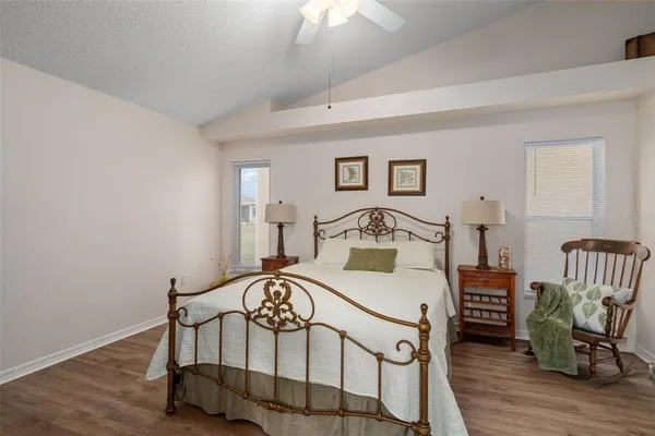 a bedroom with a bed a table and chair