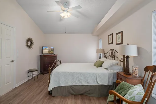 a bedroom with a bed and wooden floor