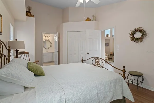 a bedroom with a bed and chandelier