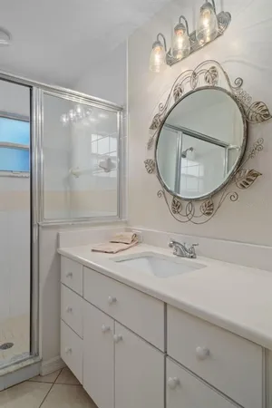 a bathroom with a sink mirror and vanity