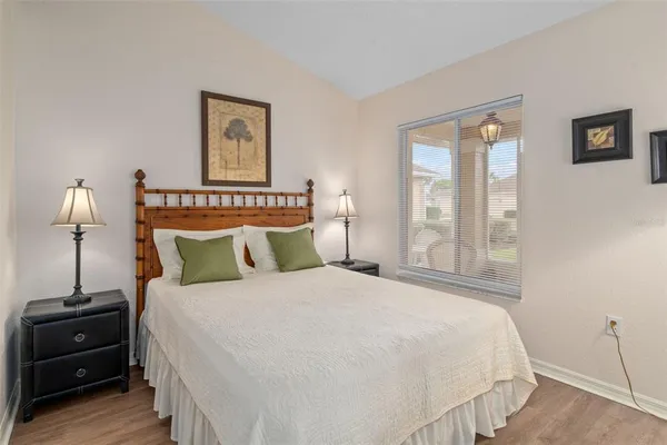 a bedroom with a bed and a night stand